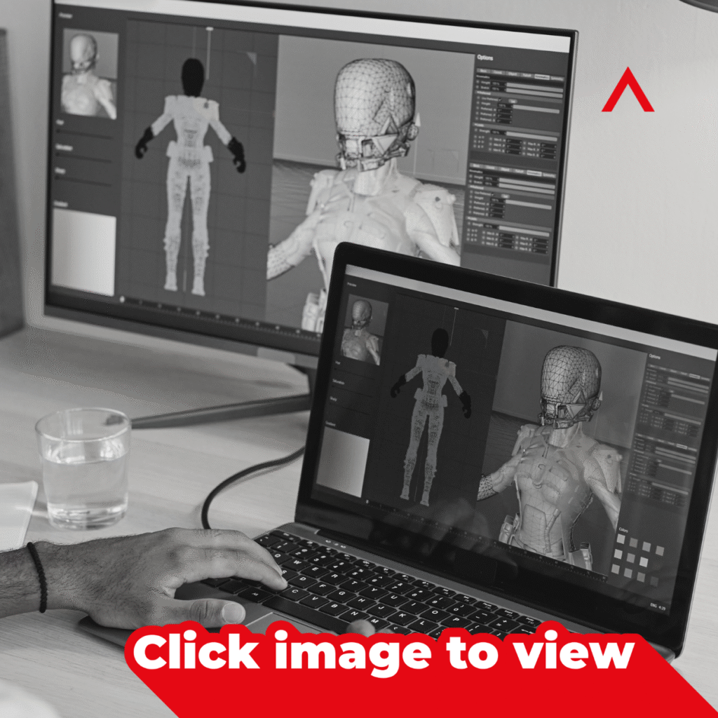 Designer working on 3D motion graphics character model on a laptop and monitor in a creative workspace.